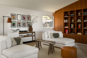 Two white lounge sofas in a library in a Los Angeles, California home library.
